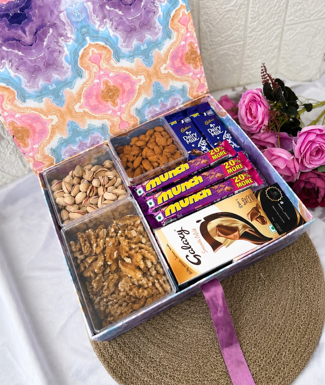 A marble-print gift box loaded with pistachios, almonds, walnuts and a generous mix of Cadbury, Munch and Galaxy chocolates.