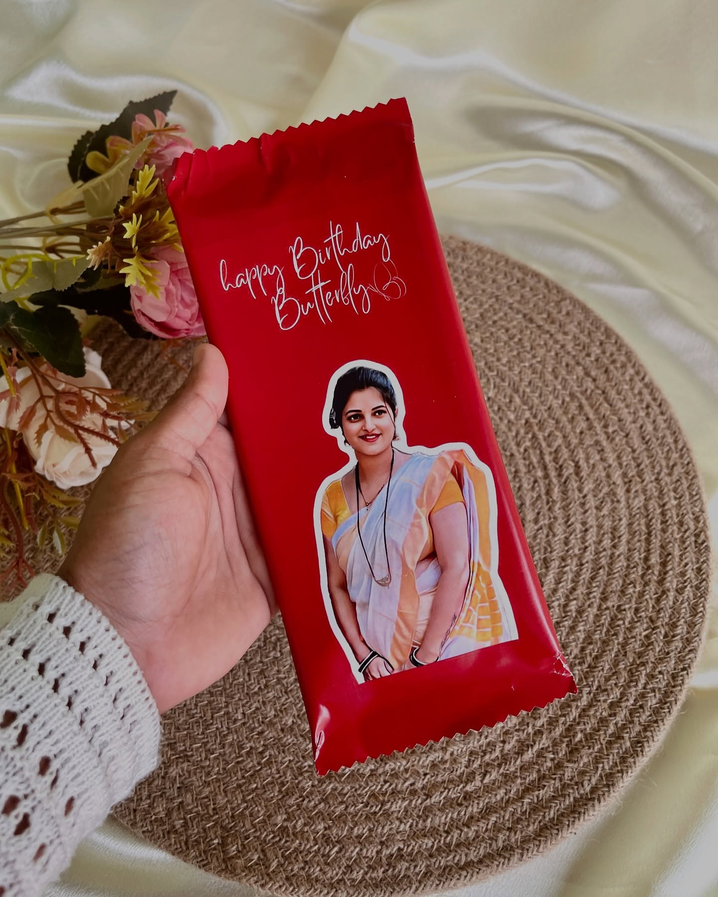 A large chocolate bar wrapped with a custom Happy Birthday message and a printed photo.