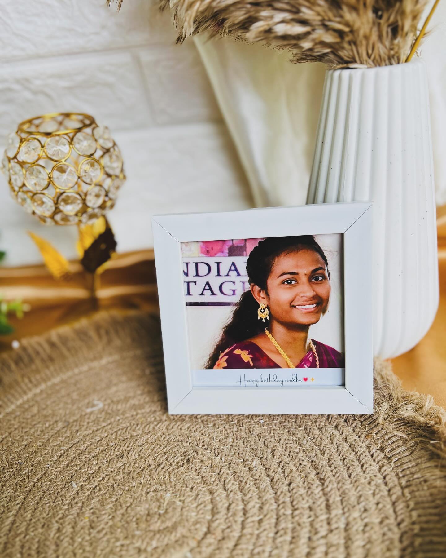 A simple white photo frame personalised with a birthday photo and handwritten wish.