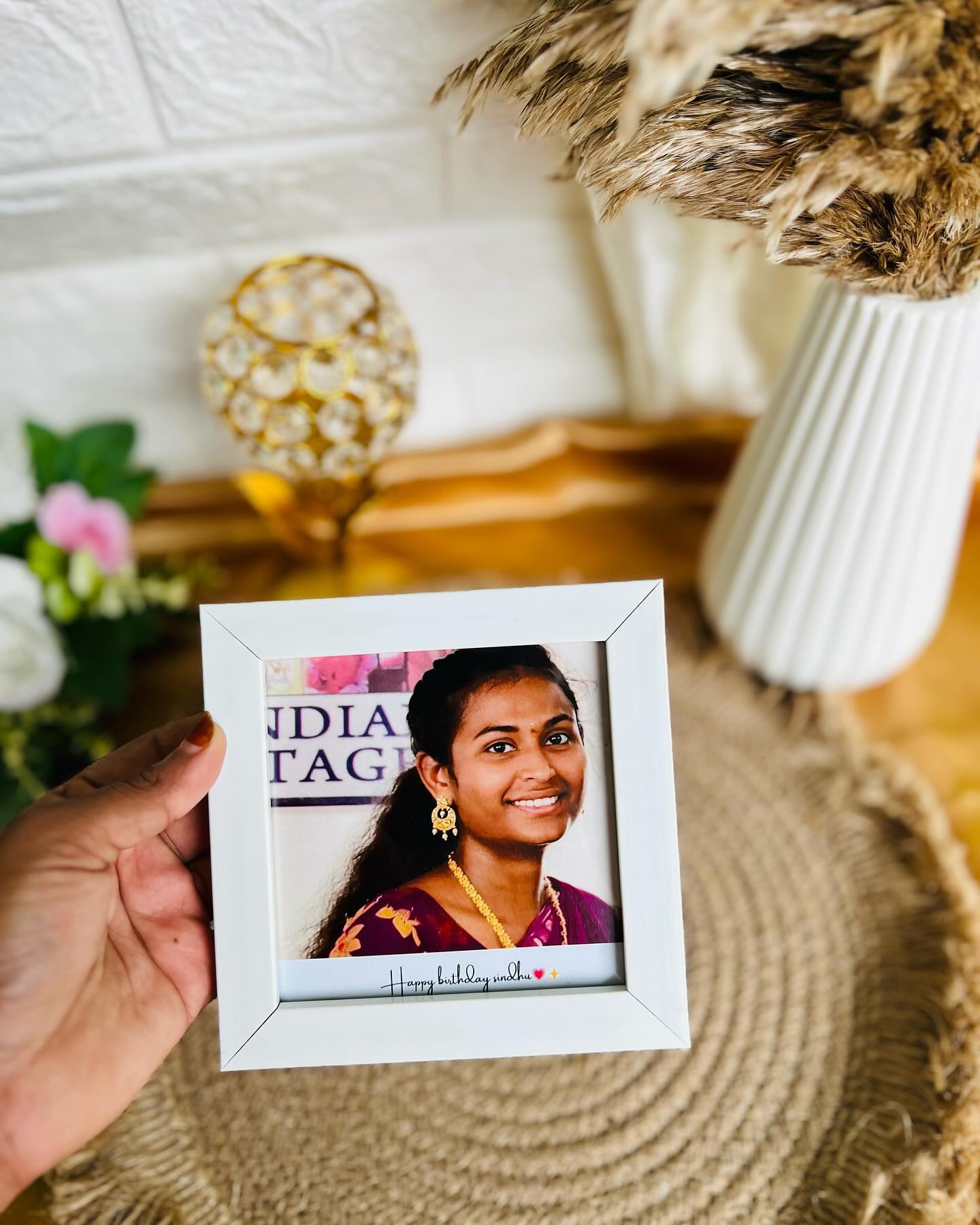 A compact white photo frame personalized with a birthday portrait and a custom name caption.