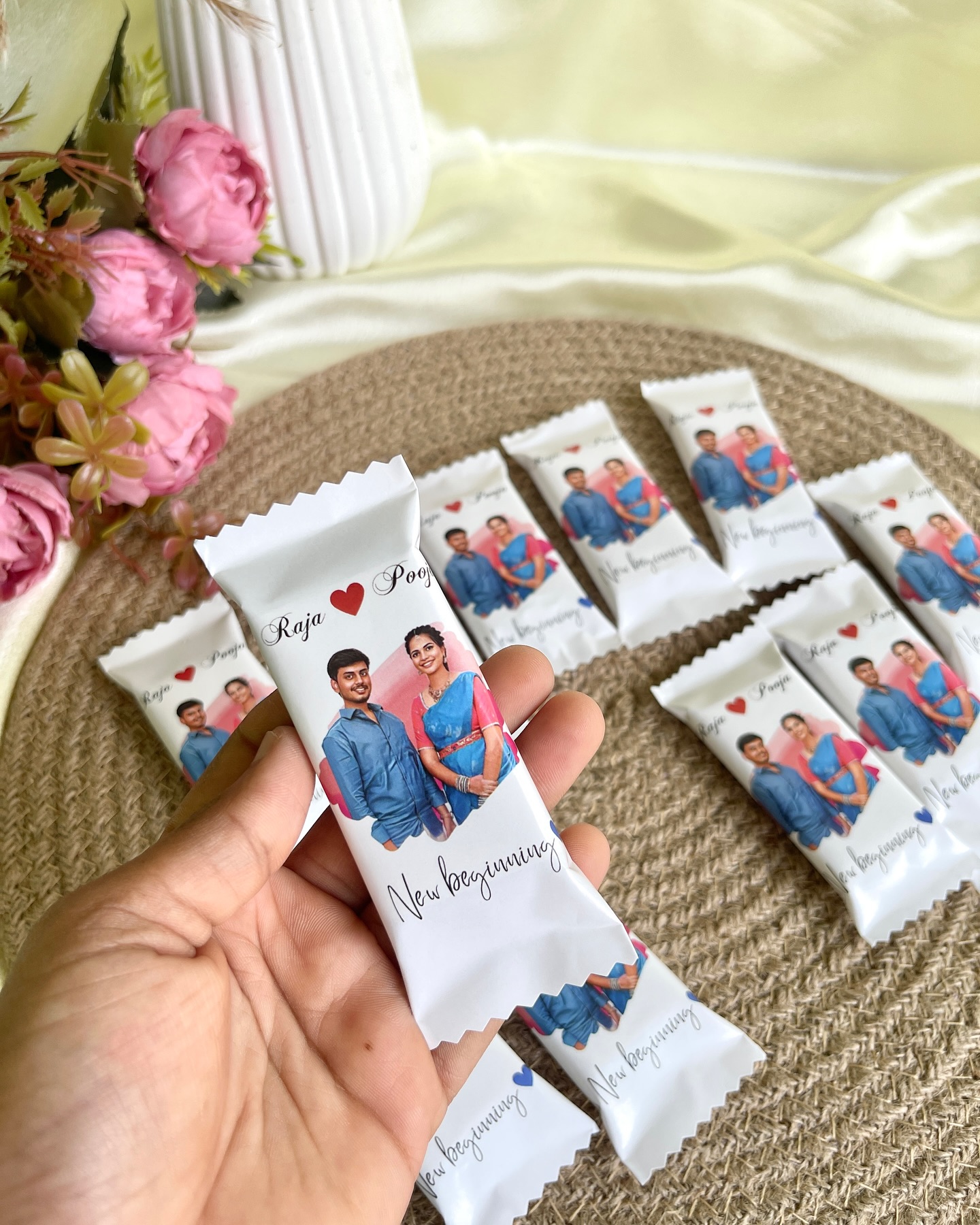 Personalized chocolate bars printed with a couple's photo, names, and a New Beginning message for wedding favours.