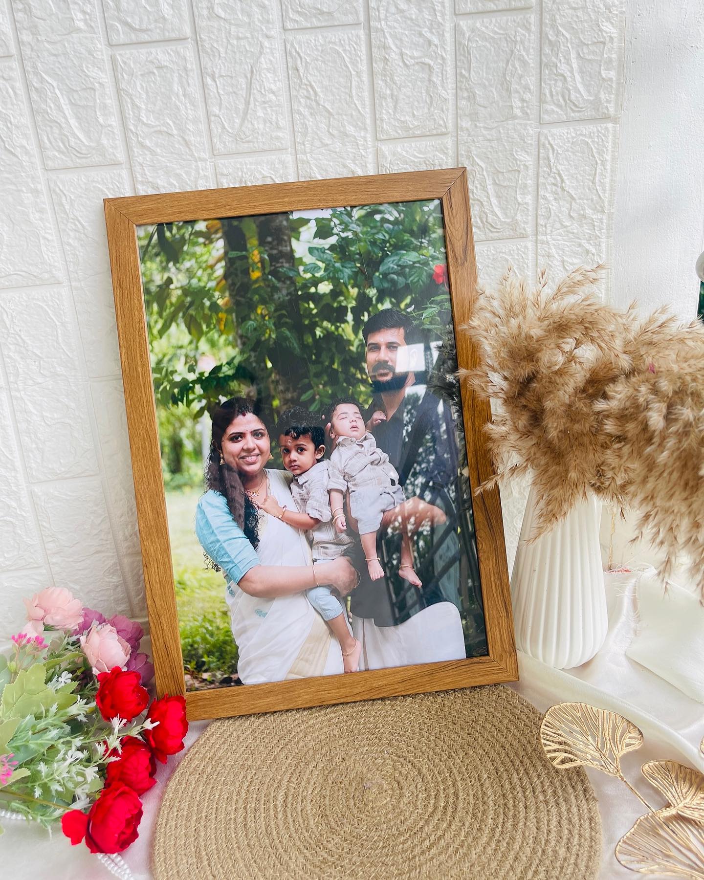 A warm wooden-framed print of a cherished family photo, styled with soft florals.