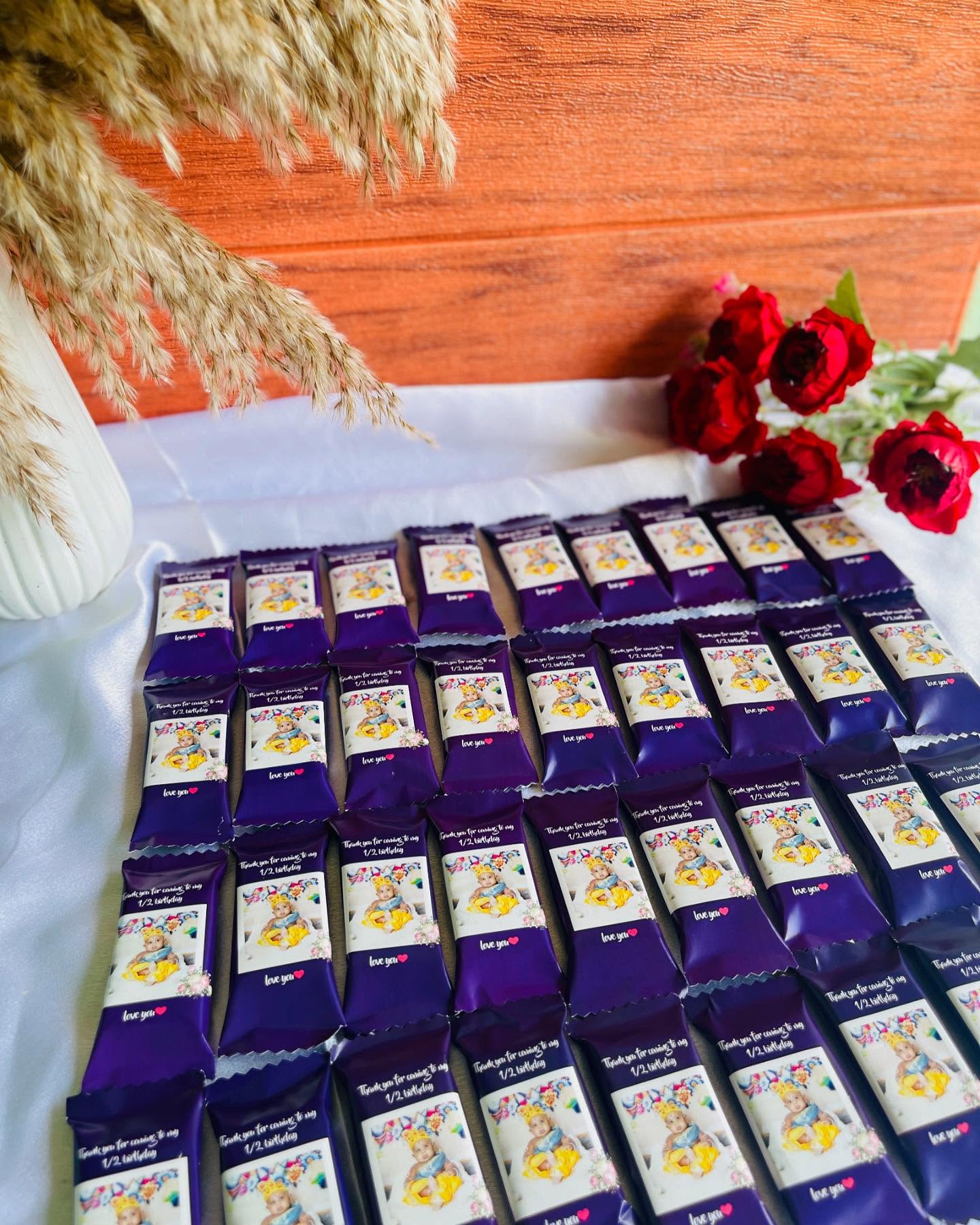 A tray of chocolate bars individually wrapped with your little one's photo to mark their half birthday.