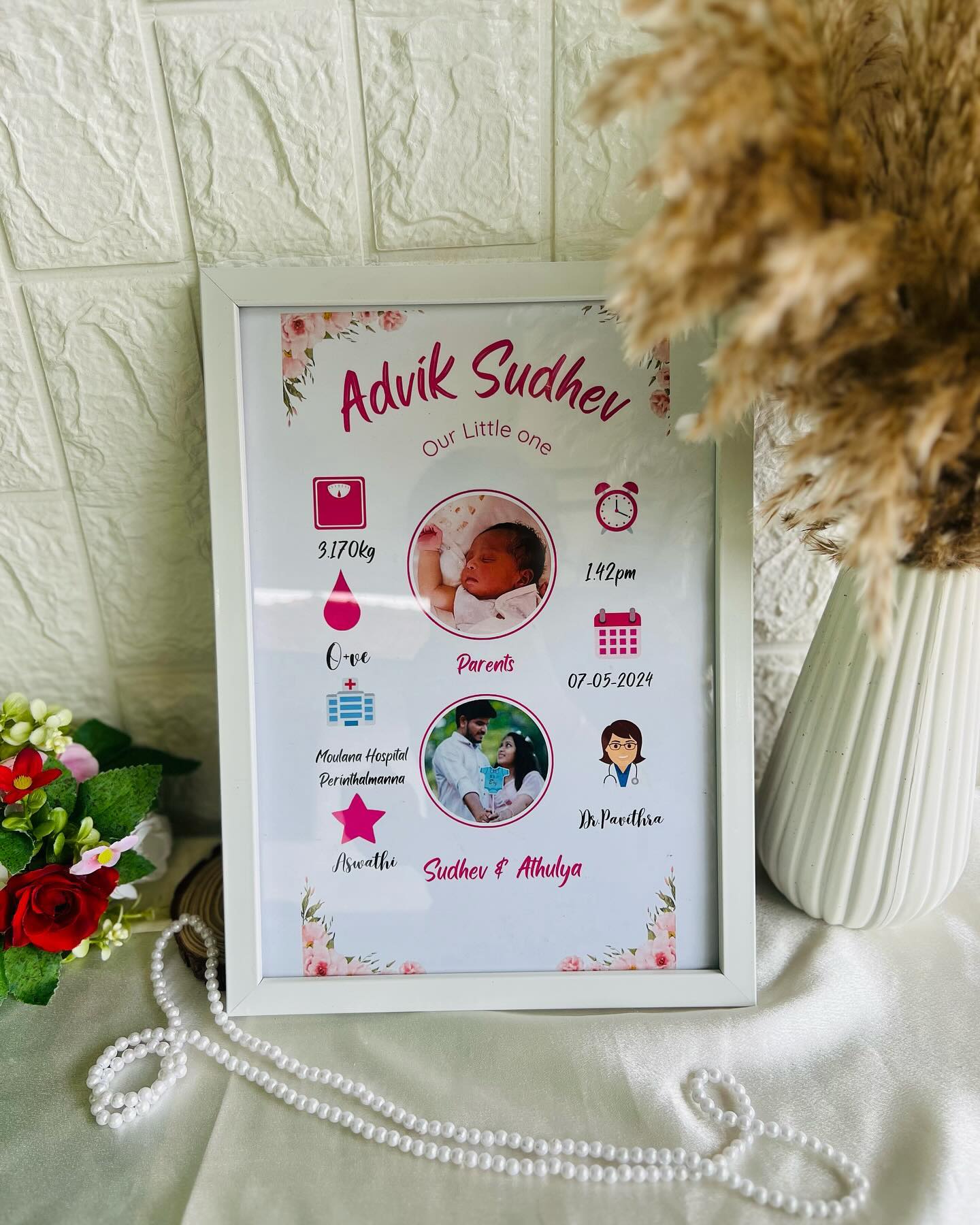 A framed keepsake poster detailing a newborn's name, weight, birth time, and parents' photo for a new-baby gift.