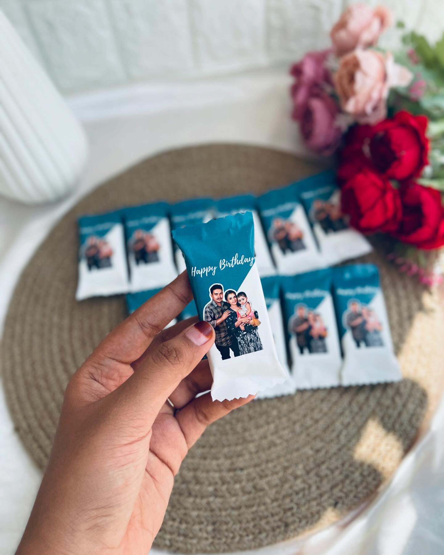 A set of individually wrapped chocolate bars printed with a custom family photo and "Happy Birthday" message.