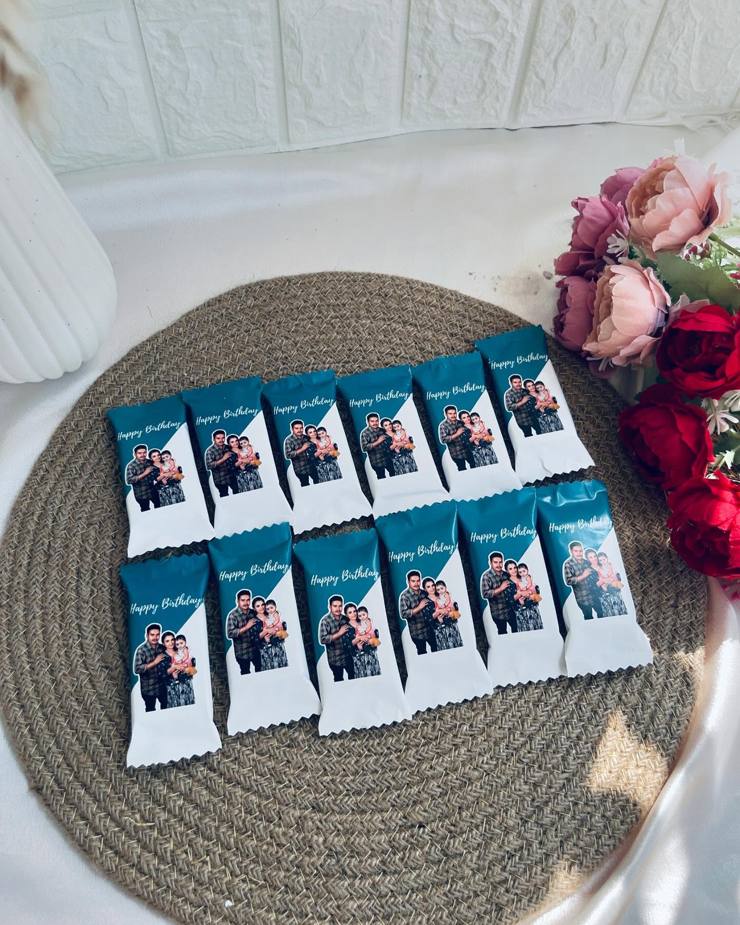 A dozen individually wrapped chocolate bars printed with a favourite family photo and a birthday message.