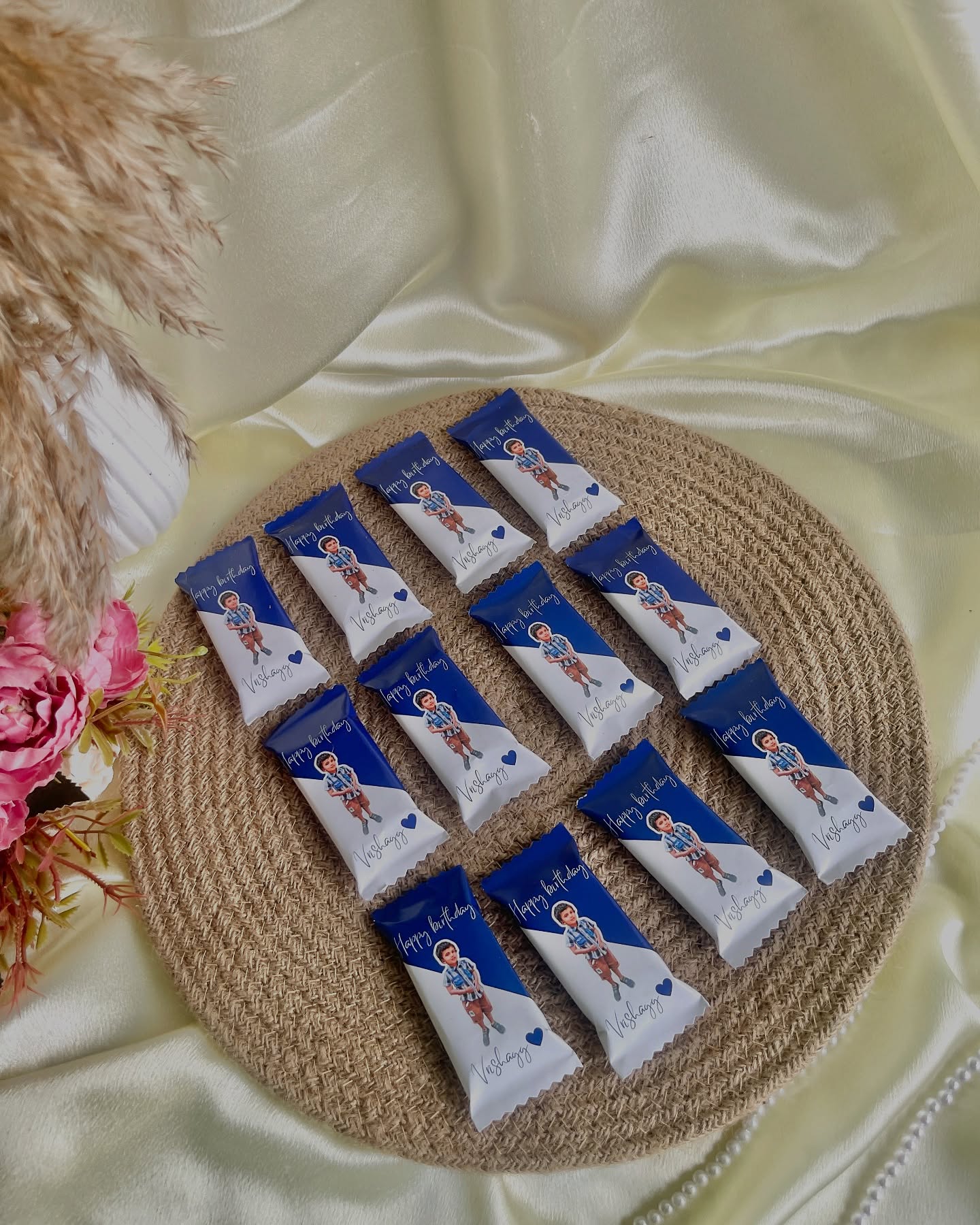 A set of 12 chocolate bars custom-wrapped with a photo, name, and 'Happy Birthday' message.