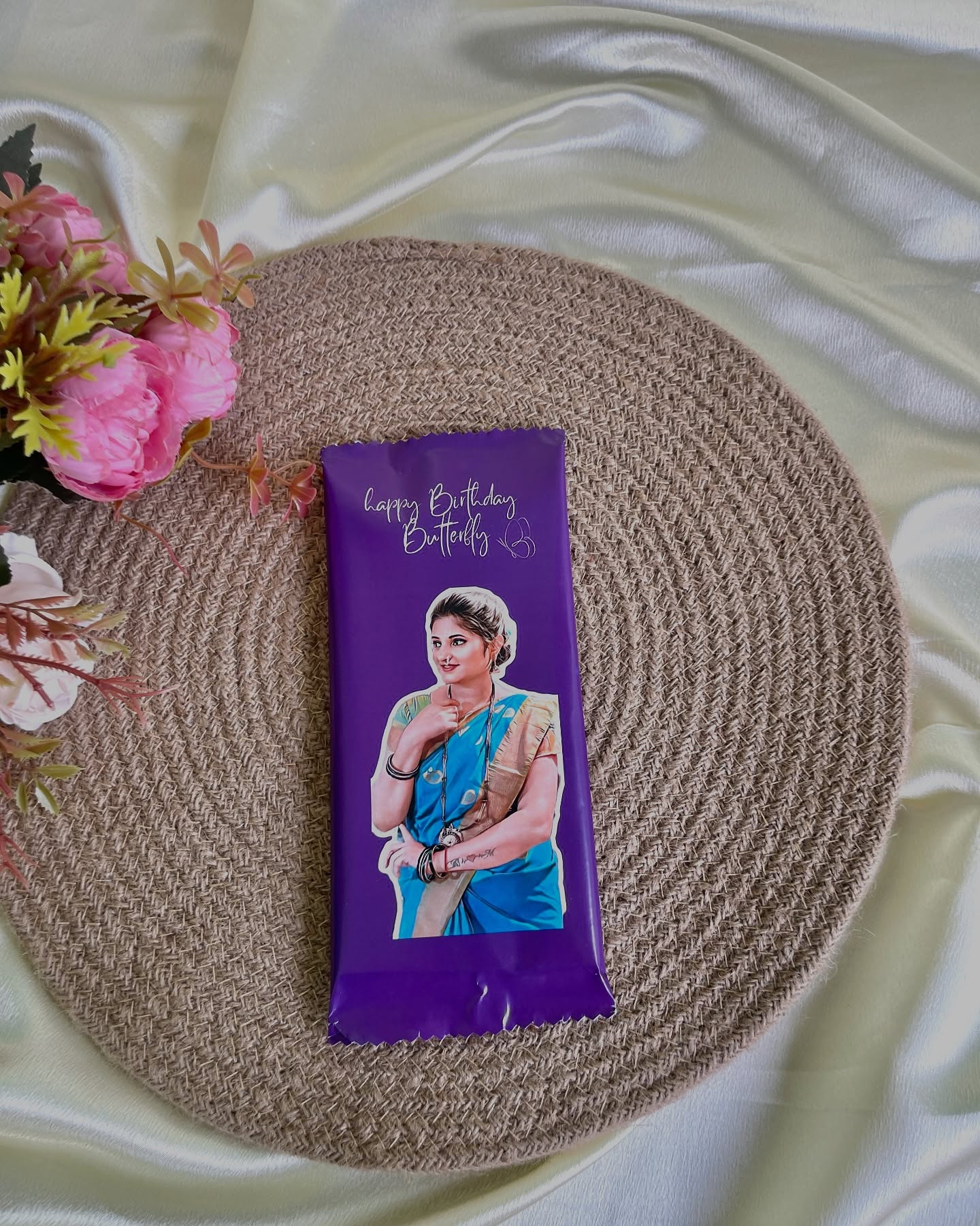 A custom-wrapped chocolate bar printed with a personal photo and a 'Happy Birthday Butterfly' message.