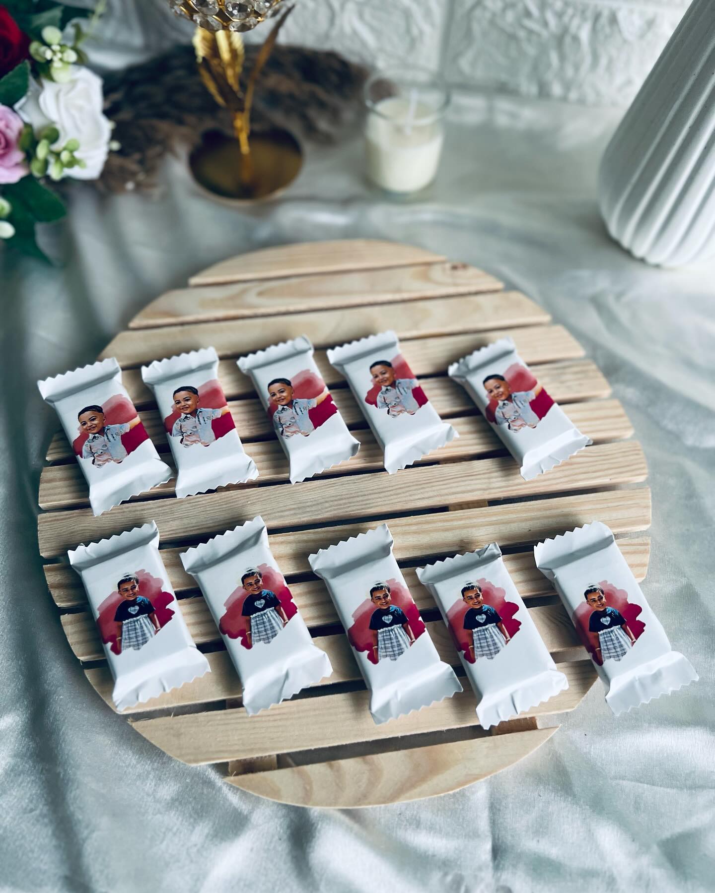 A set of mini chocolate bars individually wrapped with a child's printed photo, perfect as party favors.