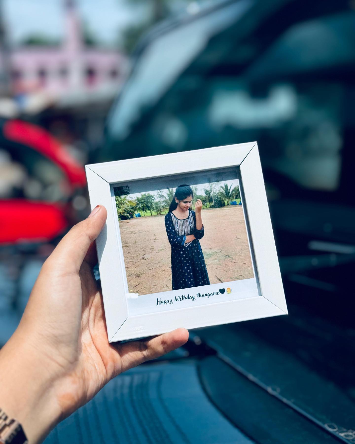 A simple white photo frame personalized with a custom photo and a handwritten-style birthday message.