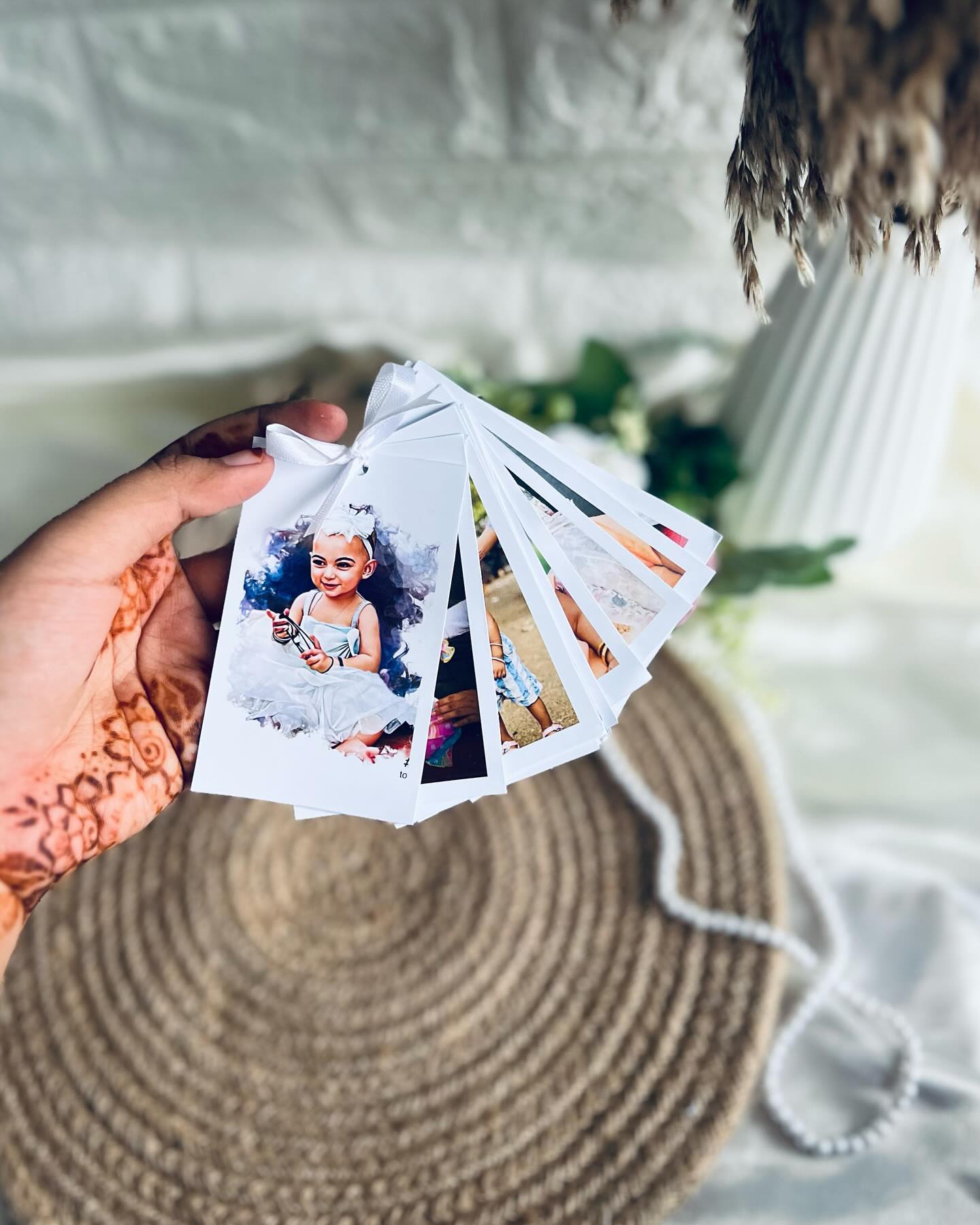 A ribbon-tied fan of custom-printed photo tags turning cherished memories into a keepsake you can hold.