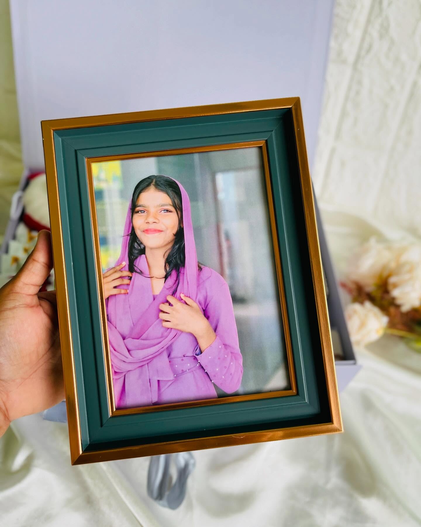 A gold and green bordered frame personalized with a warm portrait photo, a lovely keepsake gift.