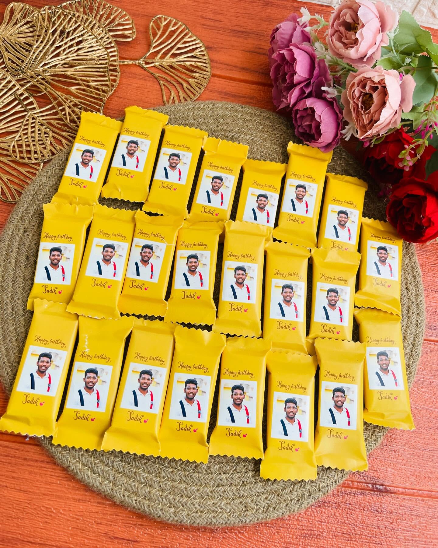 A generous set of chocolate bars individually wrapped with a photo and personalized birthday message, great for sharing the celebration.