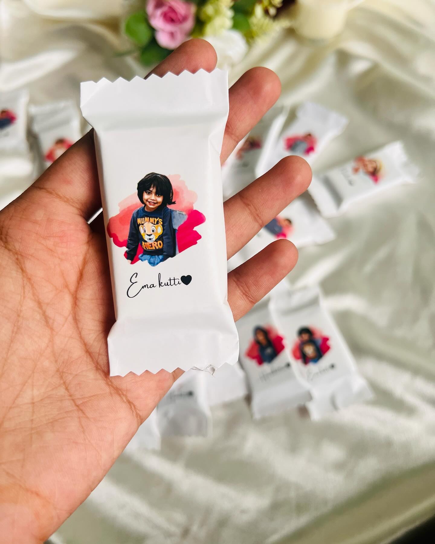 Personalized chocolate bars wrapped with a printed photo and name, ideal as sweet party favors.