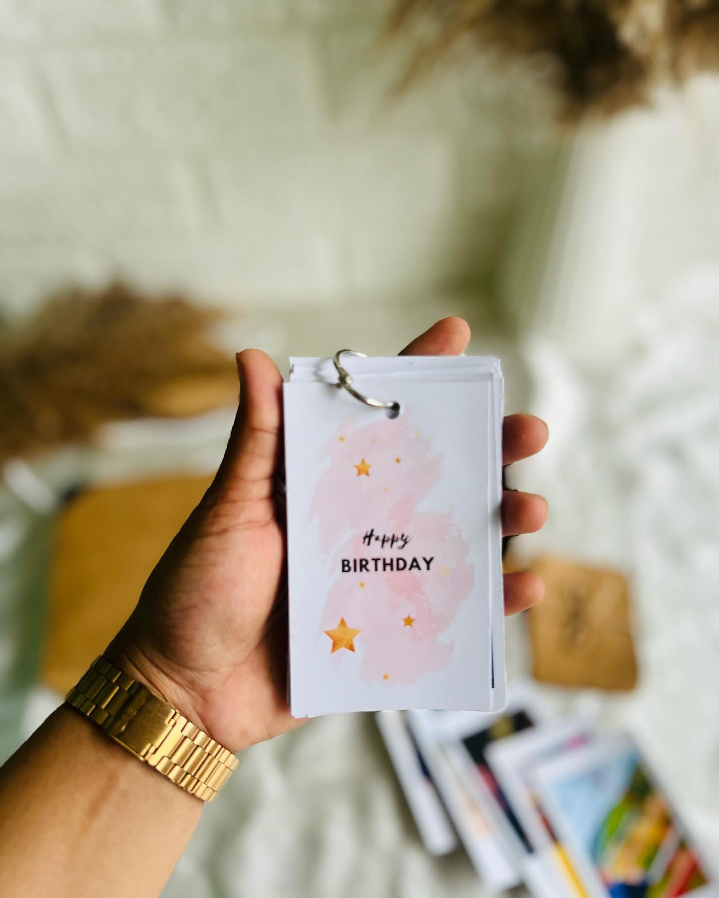 A kraft gift box filled with polaroid-style photo cards, a handmade keepsake photo booklet, and a KitKat treat, finished with a Happy Birthday gift bag.