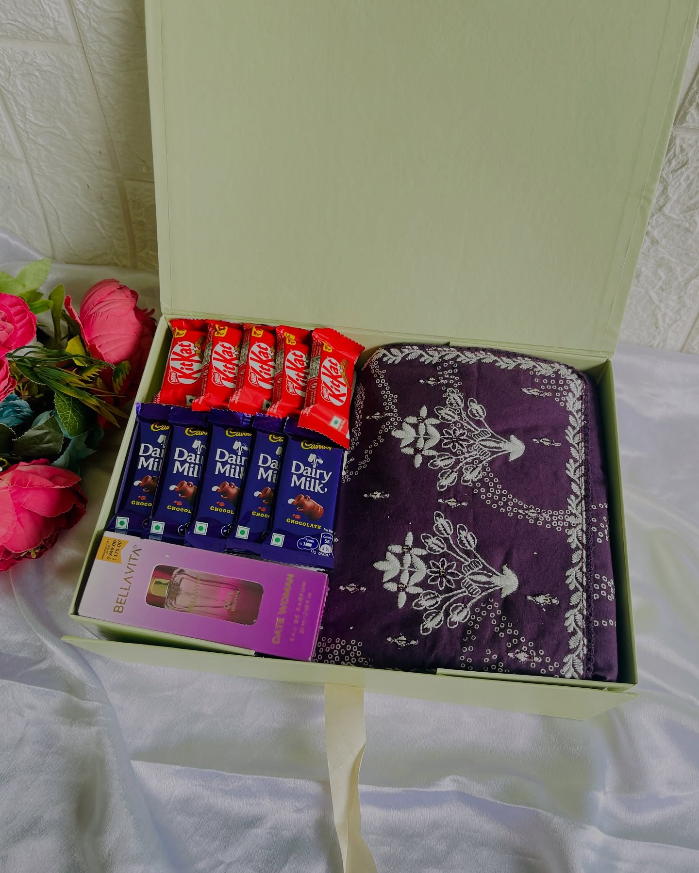 A soft pistachio gift box holding a purple embroidered shawl, KitKat and Dairy Milk chocolates, and a sweet birthday note.