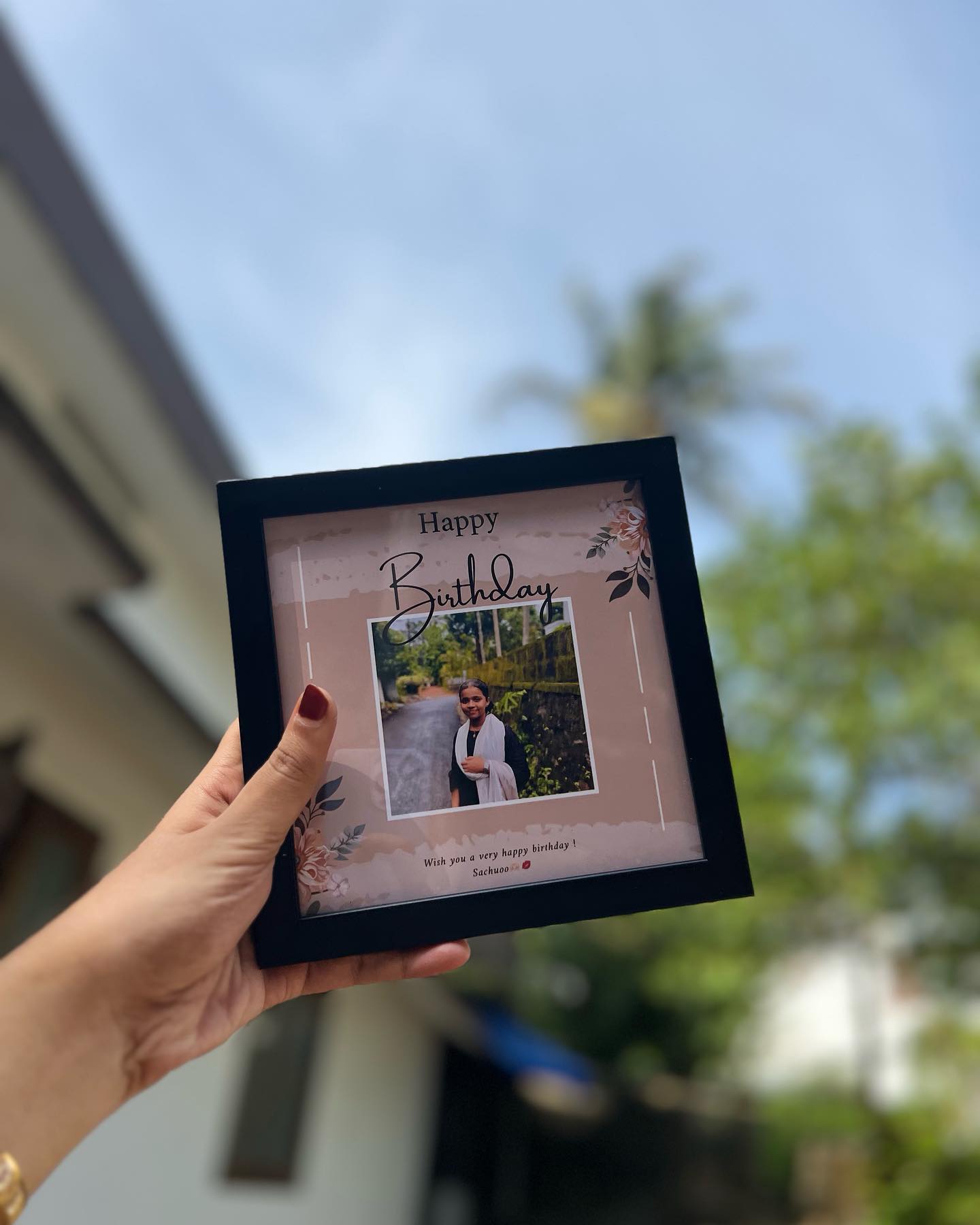 A black square photo frame printed with a personalized 'Happy Birthday' design around a favourite candid photo.