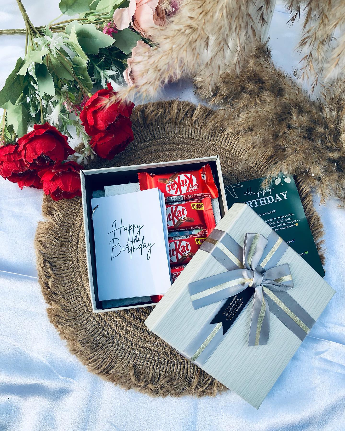 A rustic keepsake box filled with fresh roses, KitKat treats and a heartfelt handwritten birthday card.