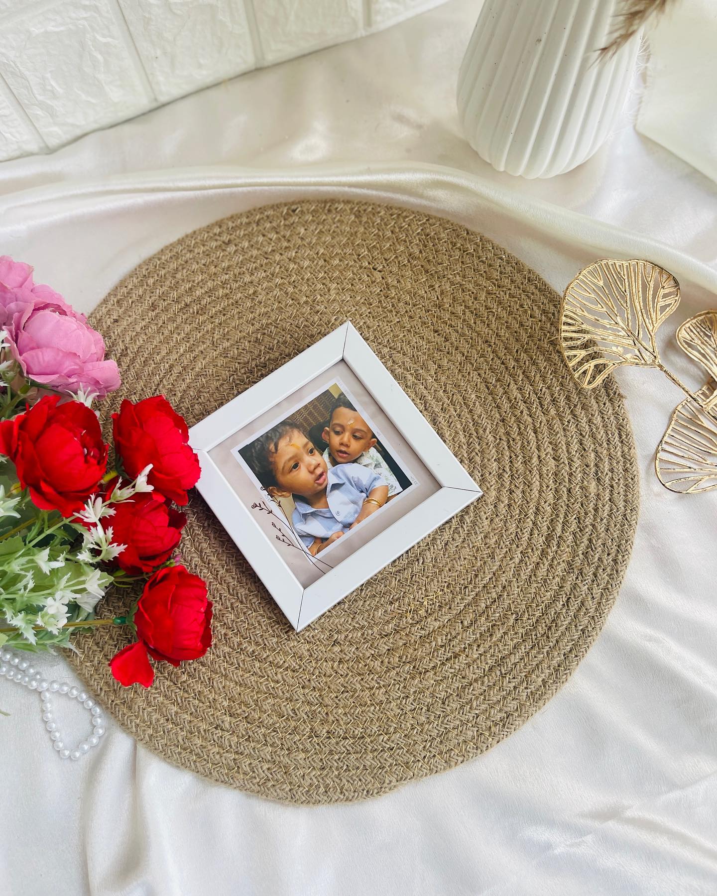 A sweet mini photo frame styled with fresh pink and red roses for a heartfelt personal gift.