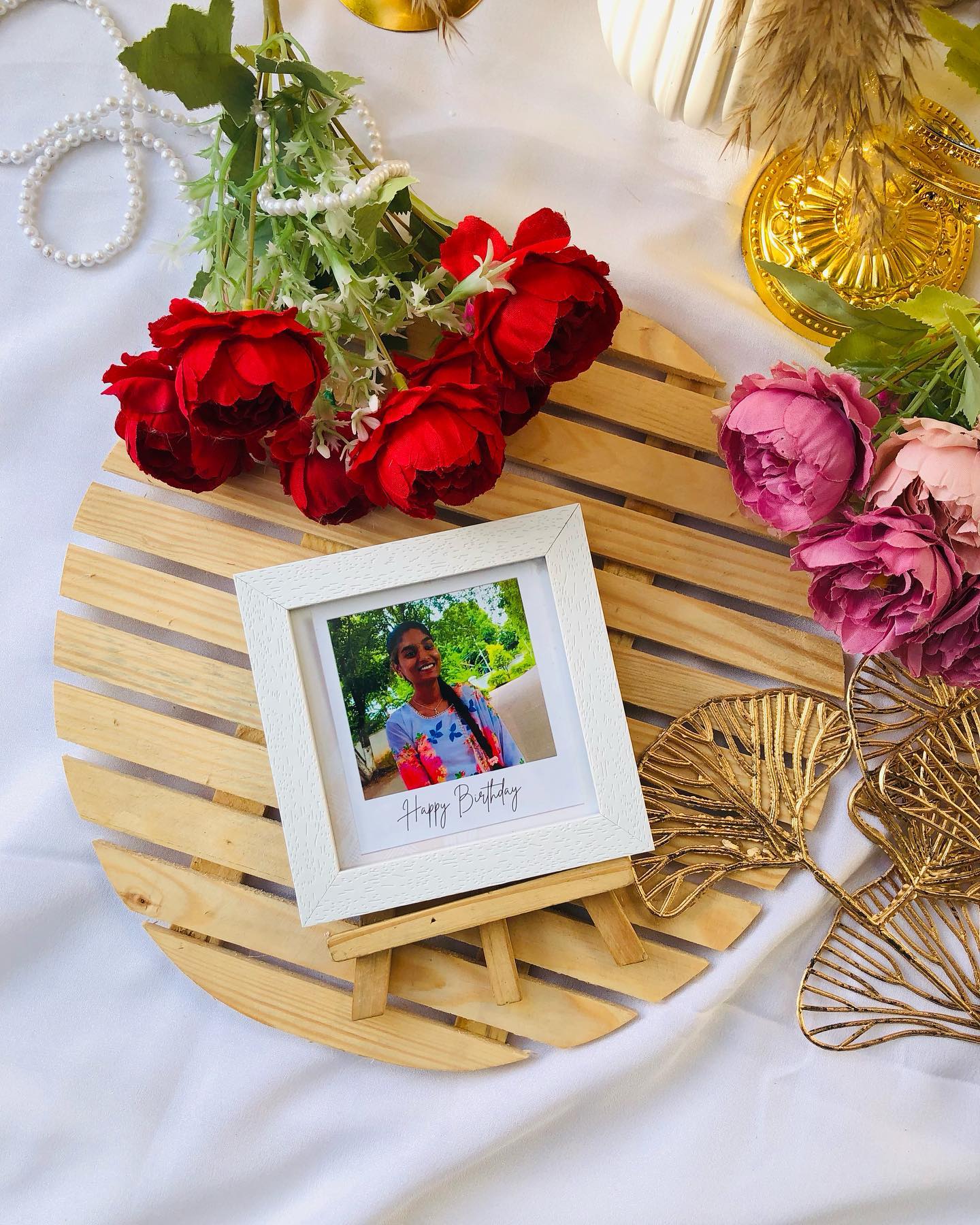 A personalized mini photo frame displayed on a charming wooden rocking easel, perfect for a birthday surprise.