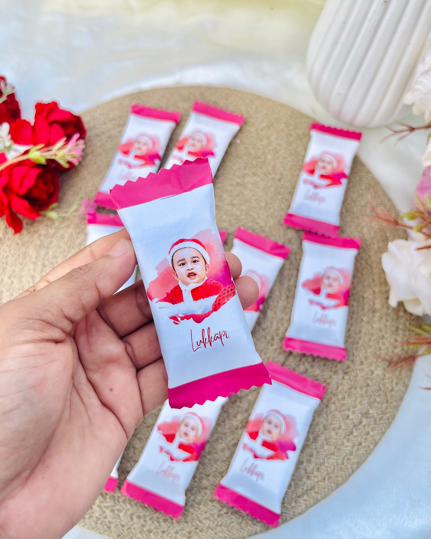 A set of mini chocolate bars each wrapped with an adorable Santa-hat baby photo, perfect as festive keepsake favors.