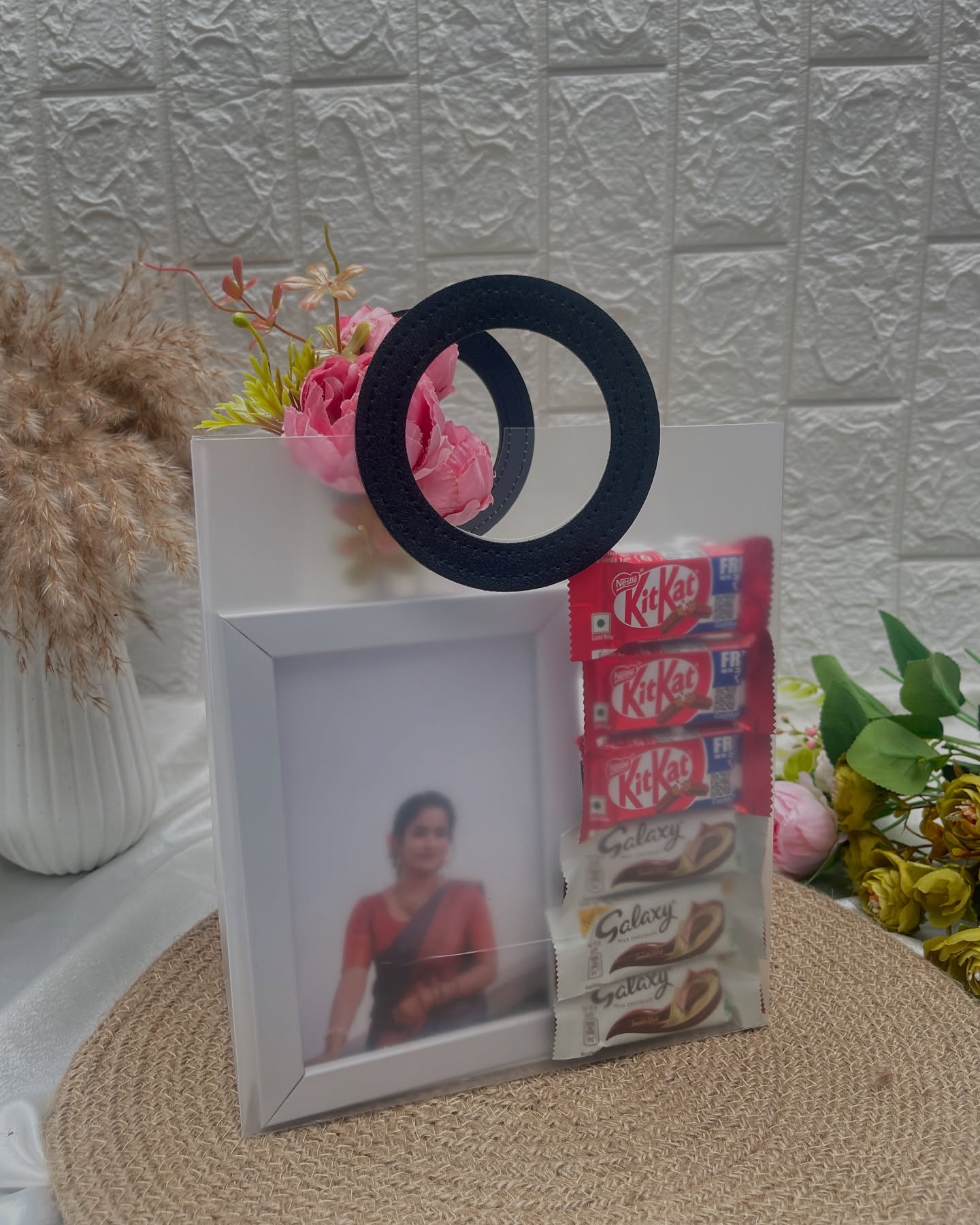 A personalized photo frame with a decorative ring accent, paired with KitKat and Galaxy chocolates.
