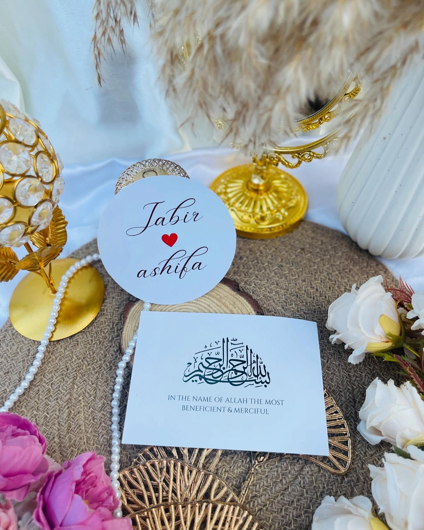 A burgundy round wooden "Save Our Date" sign on a rustic wood-slice stand.