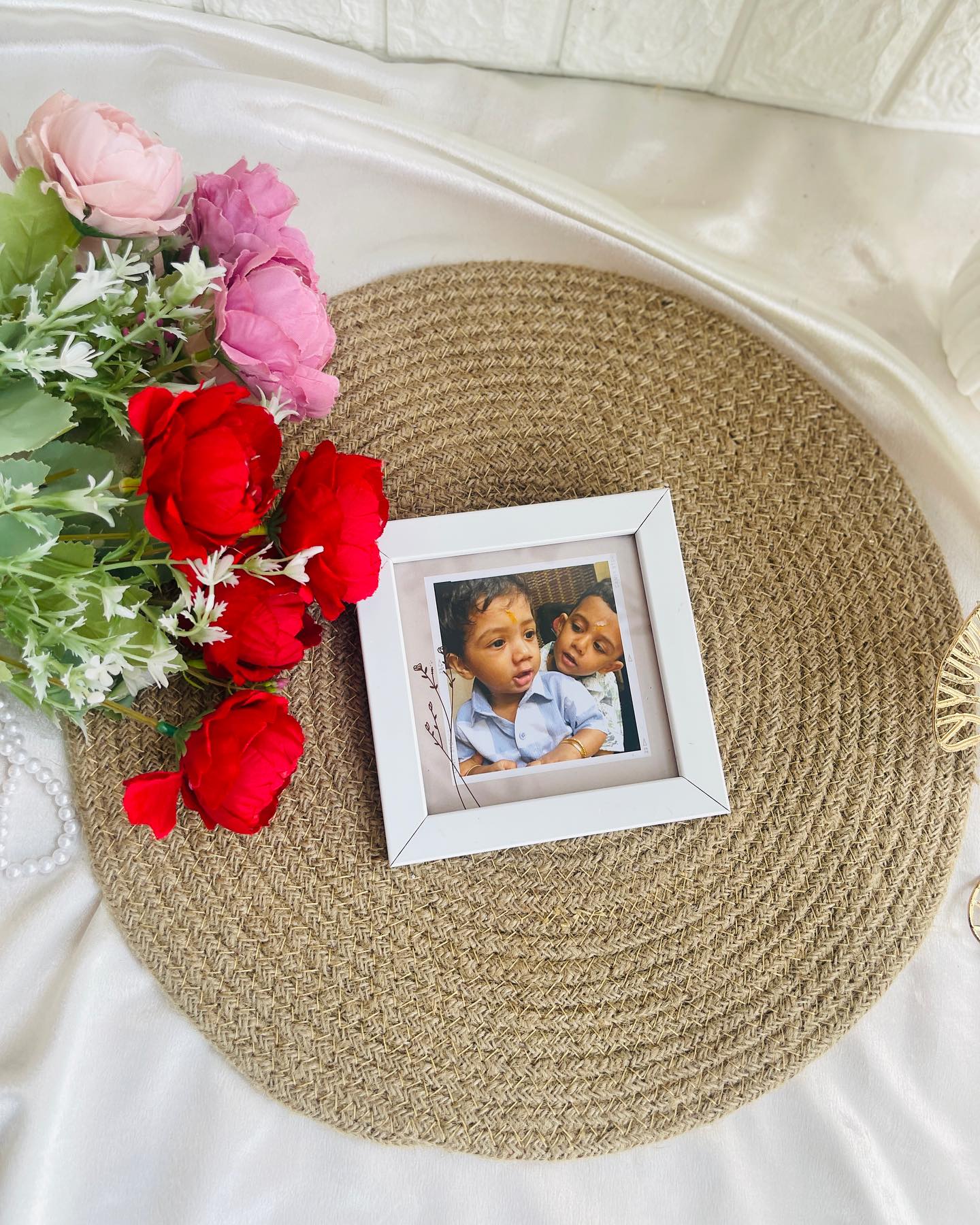 A petite white frame holding an adorable candid photo of two little siblings.