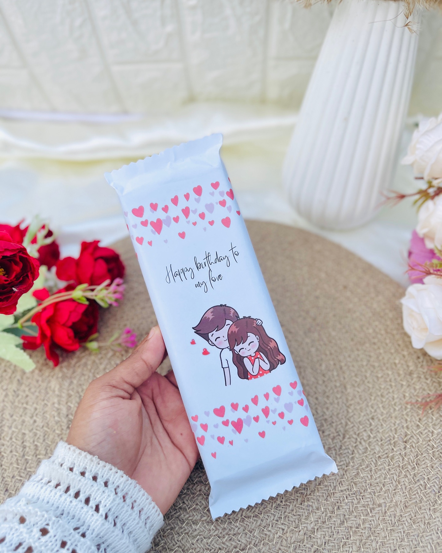 A giant personalized chocolate bar wrapped with a cute couple illustration and a "Happy Birthday to My Love" message.