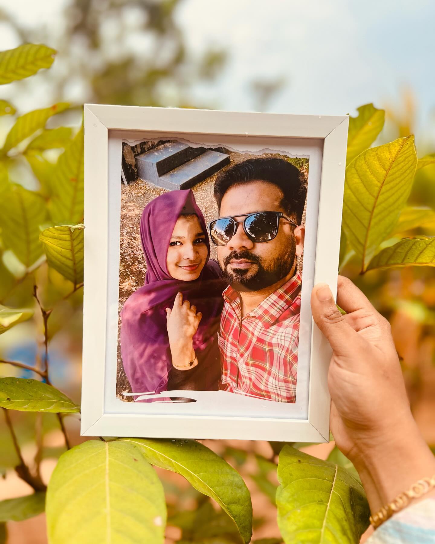 A framed keepsake photo finished with a creative torn-paper double exposure effect.