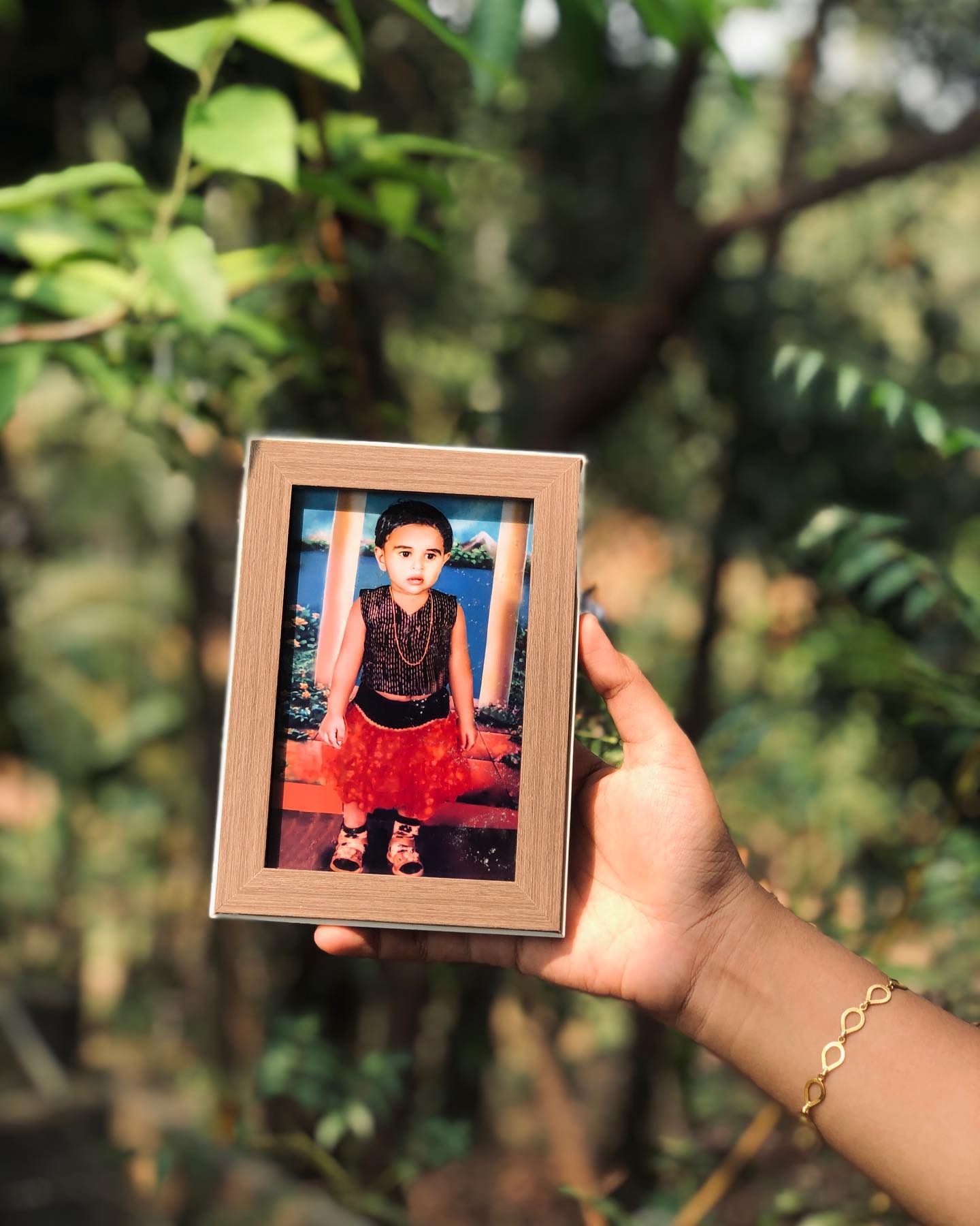 A wooden photo frame preserving a cherished vintage studio portrait as a nostalgic keepsake.