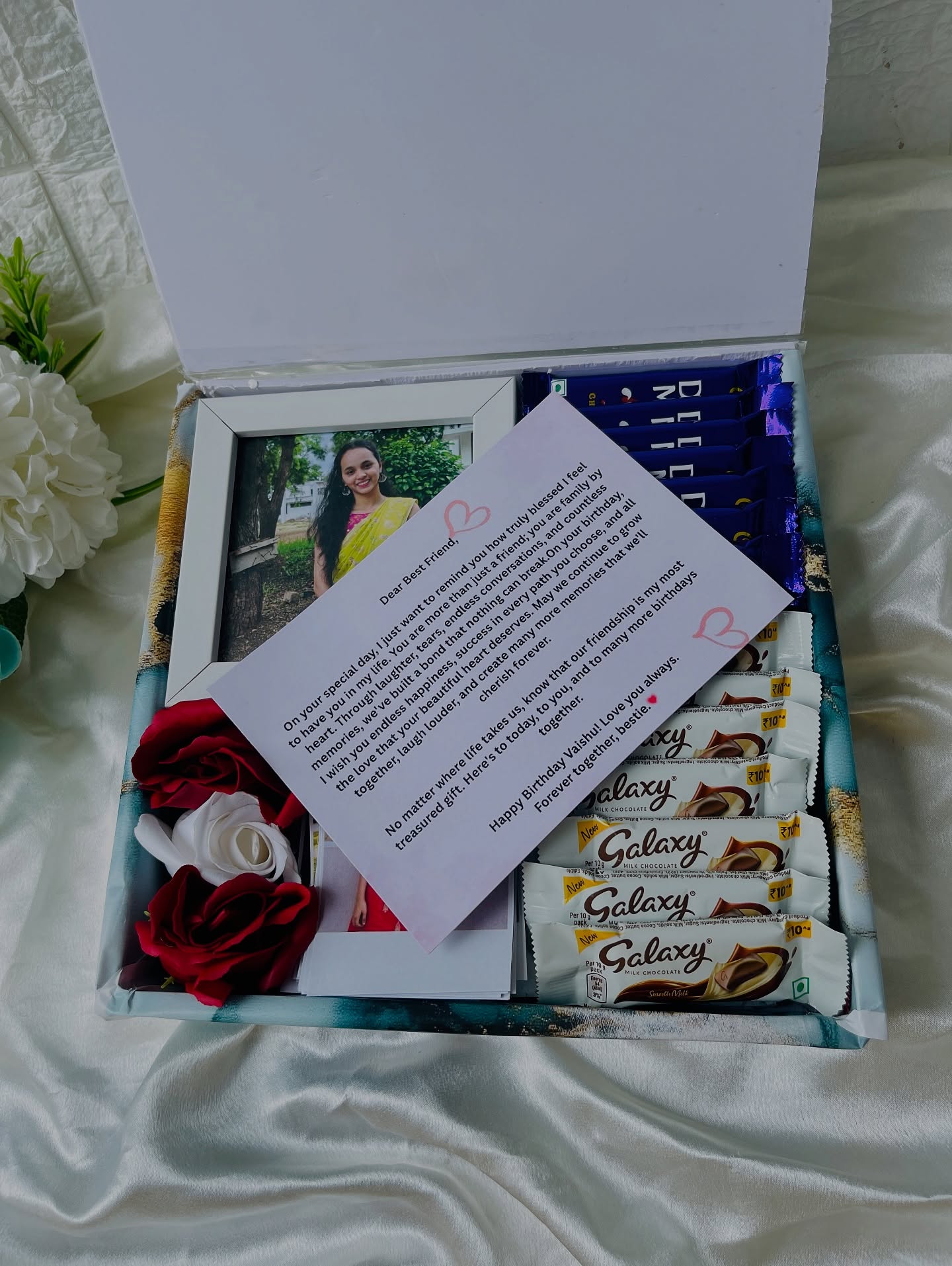 A framed photo collage of wedding and family moments with a printed calendar and Happy Anniversary message.