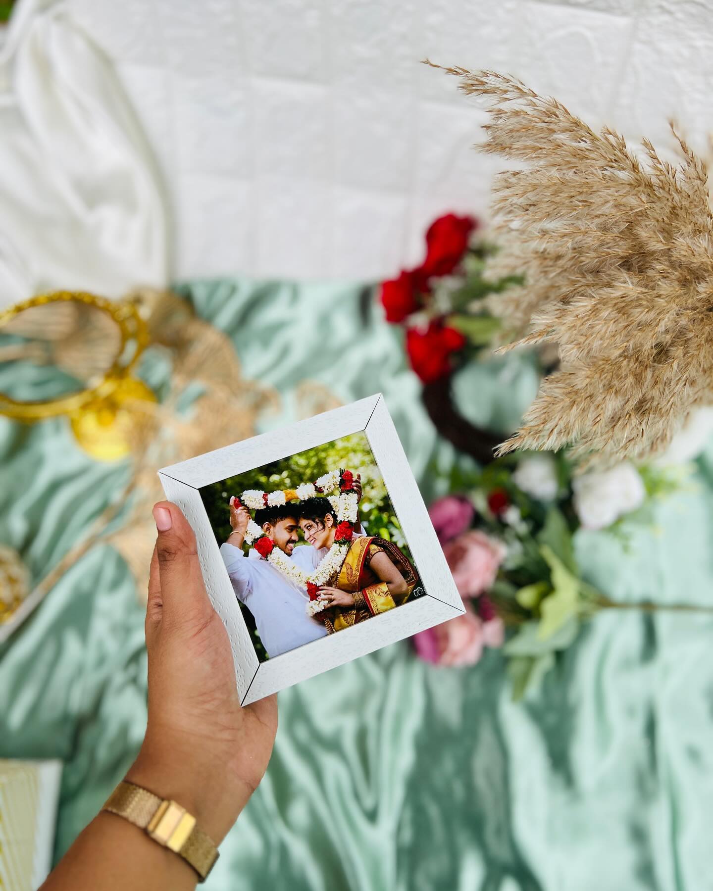 A compact white photo frame personalized with a couple's wedding-day photograph.